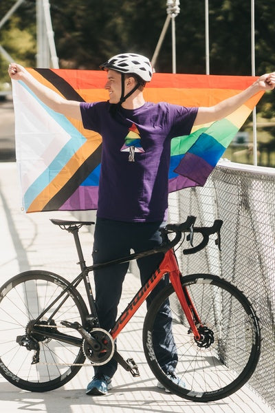 Mikah holding his pride flag.
